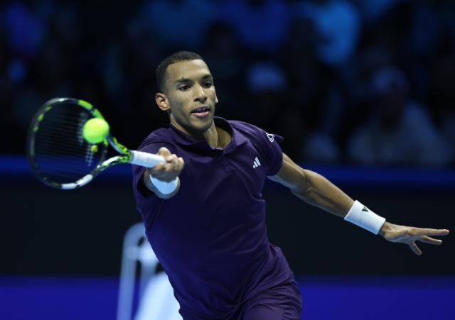 (251115) -- TURIN, Nov. 15, 2025 (Xinhua) -- Felix Auger-Aliassime hits a return during the men's singles round robin match between Alexander Zverev of Germany and Felix Auger-Aliassime of Canada at the ATP Finals tennis tournament in Turin, Italy, on Nov. 14, 2025. (Xinhua/Li Jing)