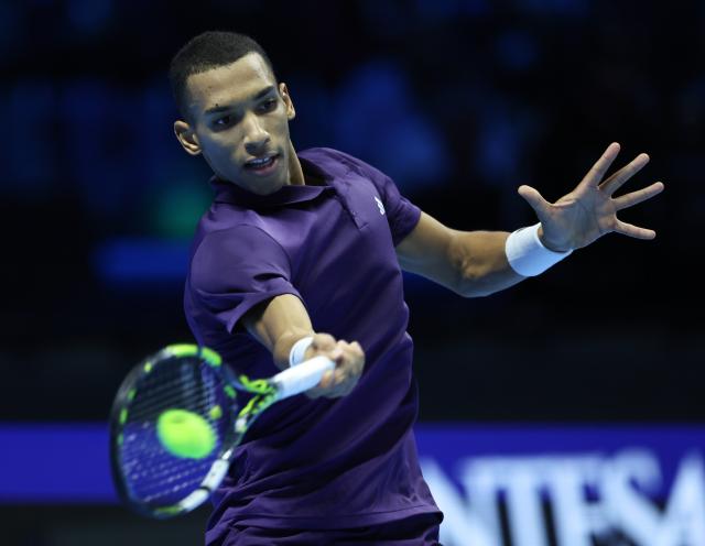 (251115) -- TURIN, Nov. 15, 2025 (Xinhua) -- Felix Auger-Aliassime hits a return during the men's singles round robin match between Alexander Zverev of Germany and Felix Auger-Aliassime of Canada at the ATP Finals tennis tournament in Turin, Italy, on Nov. 14, 2025. (Xinhua/Li Jing)