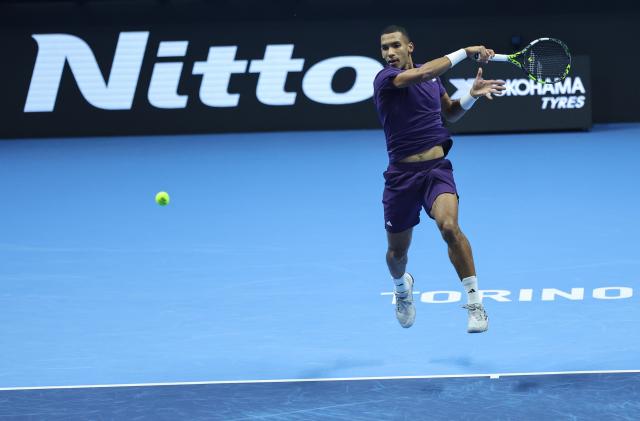 (251115) -- TURIN, Nov. 15, 2025 (Xinhua) -- Felix Auger-Aliassime hits a return during the men's singles round robin match between Alexander Zverev of Germany and Felix Auger-Aliassime of Canada at the ATP Finals tennis tournament in Turin, Italy, on Nov. 14, 2025. (Xinhua/Li Jing)