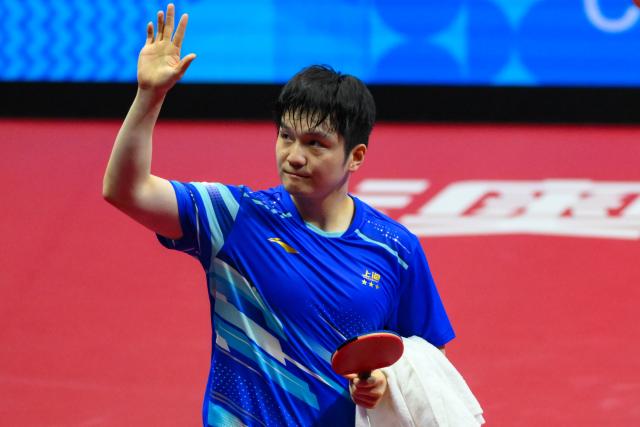 (251115) -- MACAO, Nov. 15, 2025 (Xinhua) -- Fan Zhendong waves to spectators after winning the men's singles semifinal match of table tennis between Fan Zhendong of Shanghai and Wang Chuqin of Beijing at China's 15th National Games in Macao, south China, Nov. 15, 2025. (Xinhua/Cheong Kam Ka)