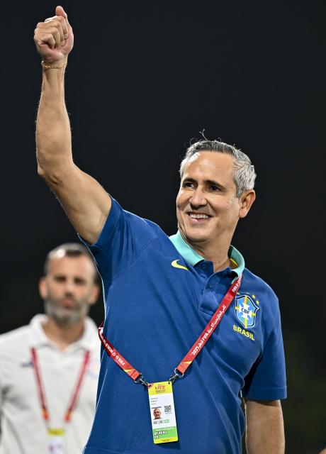 (251115) -- DOHA, Nov. 15, 2025 (Xinhua) -- Carlos Patetuci (front), head coach of Brazil, reacts prior to the round of 32 football match between Brazil and Paraguay at FIFA U17 World cup Qatar 2025 in Doha, Qatar, on Nov. 14, 2025. (Photo by Nikku/Xinhua)