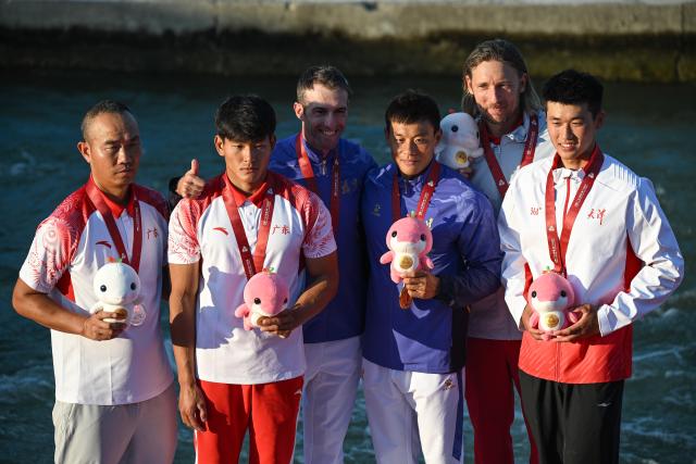 (251115) -- GUANGZHOU, Nov. 15, 2025 (Xinhua) -- Gold medalist Quan Xin (3rd R) of Fujian, silver medalist Hu Zhaoshan (2nd L) of Guangdong, bronze medalist Liu Tianchang (1st R) of Tianjin pose during the awarding ceremony for the men's kayak cross of canoe slalom at China's 15th National Games in Guangzhou, south China's Guangdong Province, Nov. 15, 2025. (Xinhua/Xiao Yijiu)