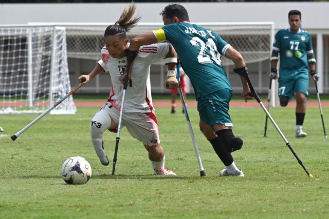 (251115) -- JAKARTA, Nov. 15, 2025 (Xinhua) -- Daiki Goto (L) of Japan vies with Jawad Kadhim Jawad Al-Janabi of Iraq during the match between Iraq and Japan at the Asian Amputee Football Cup Qualifiers 2025 in Jakarta, Indonesia, Nov. 15, 2025. (Xinhua/Agung Kuncahya B.)