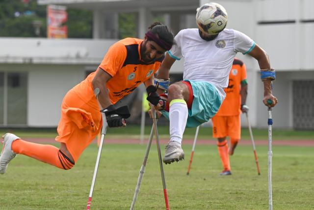 (251115) -- JAKARTA, Nov. 15, 2025 (Xinhua) -- Yadolah Gholami Zali (L) of Iran vies with Kudrat Khudoykulov of Uzbekistan during the final match between Uzbekistan and Iran at the Asian Amputee Football Cup Qualifiers 2025 in Jakarta, Indonesia, Nov. 15, 2025. (Xinhua/Agung Kuncahya B.)