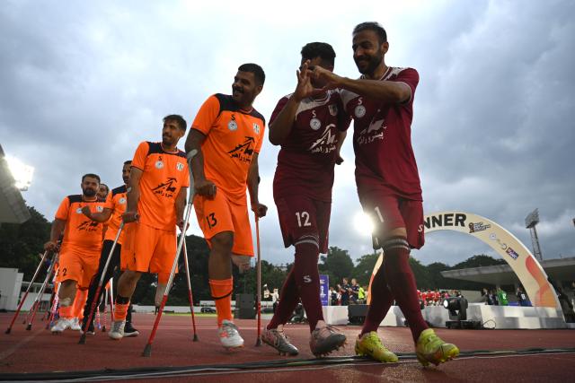 (251115) -- JAKARTA, Nov. 15, 2025 (Xinhua) -- Players of Iran gesture during the awarding ceremony after winning the final match between Uzbekistan and Iran at the Asian Amputee Football Cup Qualifiers 2025 in Jakarta, Indonesia, Nov. 15, 2025. (Xinhua/Agung Kuncahya B.)
