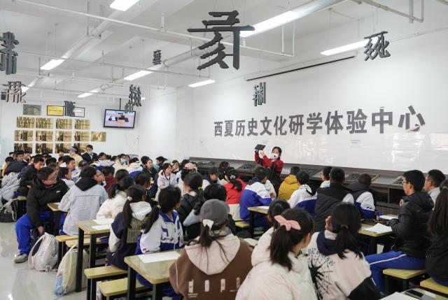 (251115) -- YINCHUAN, Nov. 15, 2025 (Xinhua) -- Students experience wooden movable-type printing at the Xixia Imperial Tombs archaeological site park in Yinchuan, northwest China's Ningxia Hui Autonomous Region, Nov. 14, 2025. Over 400 students visited the Xixia Imperial Tombs archaeological site park on Friday as a cultural event aimed at deepening their understanding of Xixia Dynasty (1038-1227) history and culture, and raising awareness of cultural heritage protection.
   The Xixia Imperial Tombs are the largest, most well-preserved and highest-ranking archaeological remains of the Xixia Dynasty and were officially added to the UNESCO World Heritage List in July 2025. (Xinhua/Yang Zhisen)