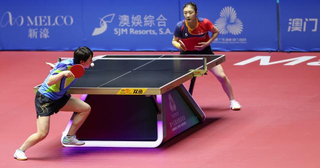 (251115) -- MACAO, Nov. 15, 2025 (Xinhua) -- Wang Manyu (L) serves during the women's singles semifinal match of table tennis between Chen Meng of Shandong and Wang Manyu of Heilongjiang at China's 15th National Games in Macao, south China, Nov. 15, 2025. (Xinhua/Liu Xu)