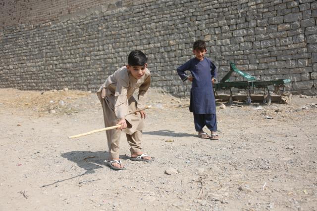 (251115) -- KHOST, Nov. 15, 2025 (Xinhua) -- Bilal Shafiq (L) plays with his friends in Khost province, Afghanistan, Oct. 28, 2025. TO GO WITH: "Feature: China returns heartbeat for Afghan child, thousands more awaiting surgeries" (Photo by Saifurahman Safi/Xinhua)