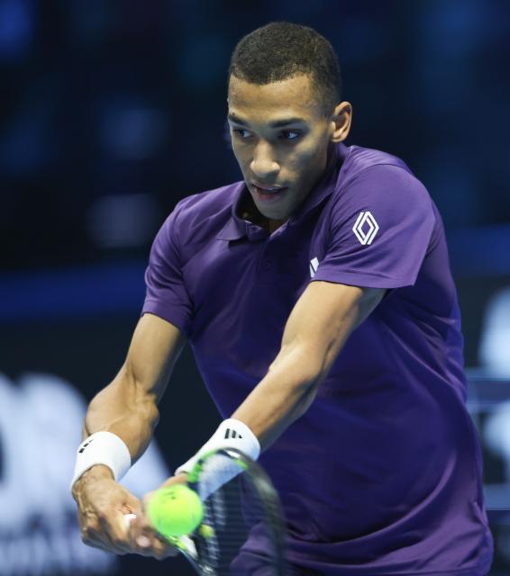 (251116) -- TURIN, Nov. 16, 2025 (Xinhua) -- Felix Auger-Aliassime returns a shot during the men's singles semifinal match between Carlos Alcaraz of Spain and Felix Auger-Aliassime of Canada at the ATP Finals tennis tournament in Turin, Italy, on Nov. 15, 2025. (Xinhua/Li Jing)