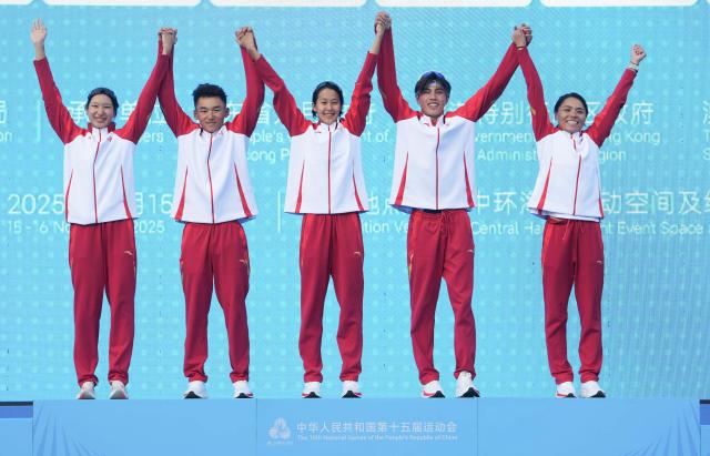 (251116) -- HONG KONG, Nov. 16, 2025 (Xinhua) -- Gold medalists team Shandong celebrate during the awarding ceremony for the triathlon mixed relay at China's 15th National Games in Hong Kong, south China, Nov. 16, 2025. (Xinhua/Lui Sui Wai)