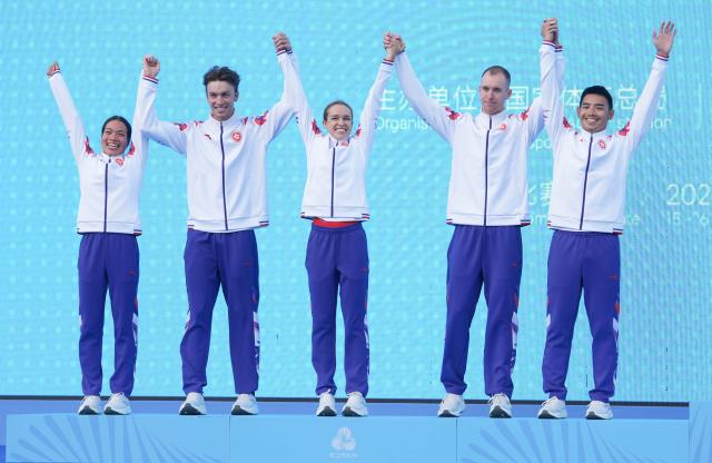 (251116) -- HONG KONG, Nov. 16, 2025 (Xinhua) -- Silver medalists team Hong Kong celebrate during the awarding ceremony for the triathlon mixed relay at China's 15th National Games in Hong Kong, south China, Nov. 16, 2025. (Xinhua/Lui Sui Wai)