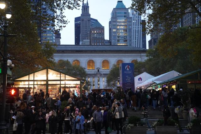 (251116) -- NEW YORK, Nov. 16, 2025 (Xinhua) -- People visit the Winter Village at Bryant Park in New York, the United States, on Nov. 15, 2025. Featuring a holiday market, a skating rink and a food hall, the Winter Village is a popular winter holiday destination at Bryant Park. (Xinhua/Zhang Fengguo)