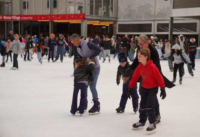 (251116) -- NEW YORK, Nov. 16, 2025 (Xinhua) -- People skate on an ice rink of the Winter Village at Bryant Park in New York, the United States, on Nov. 15, 2025. Featuring a holiday market, a skating rink and a food hall, the Winter Village is a popular winter holiday destination at Bryant Park. (Xinhua/Zhang Fengguo)