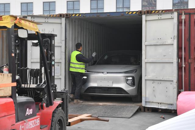 (251116) -- XI'AN, Nov. 16, 2025 (Xinhua) -- Workers load a new energy vehicle onto a container at the Kazakhstan-Xi'an port of the Xi'an International Port Station in Xi'an, northwest China's Shaanxi Province, Nov. 14, 2025. Launched in 2013, the China-Europe freight train in Xi'an has ranked first nationwide in key aspects such as the number of trains, freight volume and laden-container ratio for many years. 
  Today, the Xi'an International Port Station operates 59 railway routes, with a designed annual container throughput of 5.4 million 20-foot equivalent units (TEUs). Projects such as the Kazakhstan-Xi'an port have been completed and put into operation, facilitating trade and transportation with Europe and Asia, accelerating the city's transformation into a modern international trade and logistics hub. (Xinhua/Shao Rui)