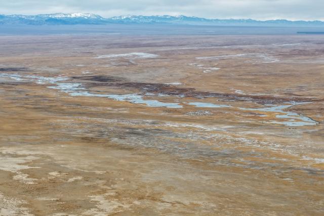(251116) -- AKSAY, Nov. 16, 2025 (Xinhua) -- An aerial drone photo taken on Nov. 16, 2025 shows the waterway connecting the Dasugan Lake and the Xiaosugan Lake in Kazak Autonomous County of Aksay, Jiuquan, northwest China's Gansu Province. Dasugan Lake and Xiaosugan Lake are connected and are both formed by the meltwater from the Qilian Mountains. A unique phenomenon is that the upstream Xiaosugan Lake is a freshwater lake, while the downstream Dasugan Lake is a saline lake. 
   Together, they nurture a vibrant ecological wetland in the vast Gobi Desert, serving as an important stopover and breeding habitat for migratory birds along China's migration routes. (Xinhua/Lang Bingbing)