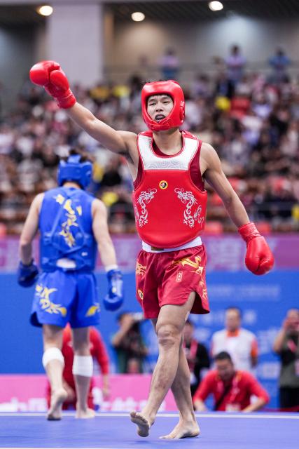 (251116) -- ZHANJIANG, Nov. 16, 2025 (Xinhua) -- Jin Wenbin (R) of Henan celebrates scoring during the 65kg event of wushu sanda men's team final at China's 15th National Games in Zhanjiang, south China's Guangdong Province, Nov. 16, 2025. (Xinhua/Li Bo)