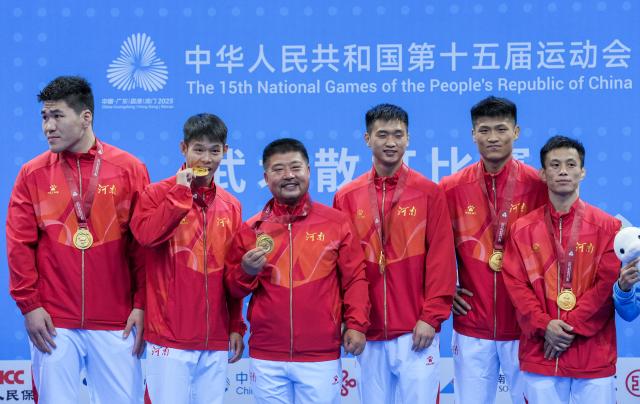 (251116) -- ZHANJIANG, Nov. 16, 2025 (Xinhua) -- Gold medalists team Henan pose during the awarding cetemony for wushu sanda men's team at China's 15th National Games in Zhanjiang, south China's Guangdong Province, Nov. 16, 2025. (Xinhua/Li Bo)