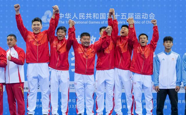 (251116) -- ZHANJIANG, Nov. 16, 2025 (Xinhua) -- Gold medalists team Henan react during the awarding cetemony for wushu sanda men's team at China's 15th National Games in Zhanjiang, south China's Guangdong Province, Nov. 16, 2025. (Xinhua/Li Bo)