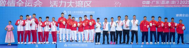 (251116) -- ZHANJIANG, Nov. 16, 2025 (Xinhua) -- Gold medalists team Henan, silver medalists team Shandong, along with bronze medalists team Beijing Sport University and team Chongqing pose during the awarding cetemony for wushu sanda men's team at China's 15th National Games in Zhanjiang, south China's Guangdong Province, Nov. 16, 2025. (Xinhua/Li Bo)
