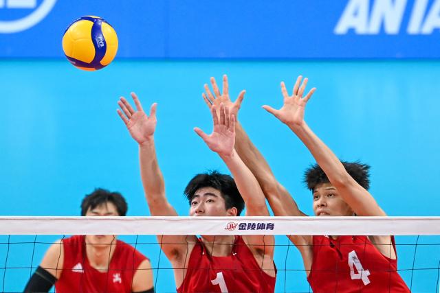 (251116) -- GUANGZHOU, Nov. 16, 2025 (Xinhua) -- Zhang Chenlei (C) and Yu Xiang (R) of Zhejiang compete during the volleyball men's U18 final between Jiangsu and Zhejiang at China's 15th National Games in Guangzhou, south China's Guangdong Province, Nov. 16, 2025. (Xinhua/Tang Yi)