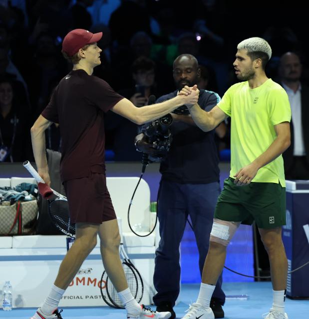 (251117) -- TURIN, Nov. 17, 2025 (Xinhua) -- Jannik Sinner (L) and Carlos Alcaraz react after the men's singles final match between Jannik Sinner of Italy and Carlos Alcaraz of Spain at the ATP Finals tennis tournament in Turin, Italy, on Nov. 16, 2025. (Xinhua/Li Jing)