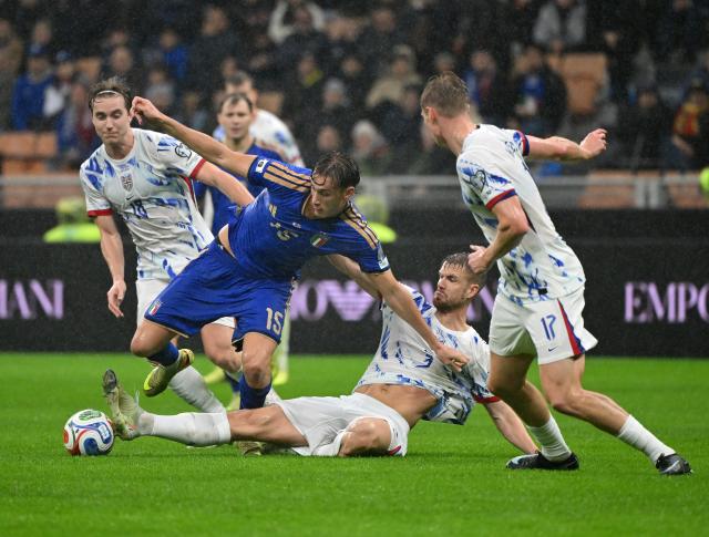 (251117) -- MILAN, Nov. 17, 2025 (Xinhua) -- Pio Esposito (2nd L) of Italy vies with Kristoffer Ajer (2nd R) of Norway during the 2026 World Cup European Qualifiers match between Italy and Norway in Milan, Italy, Nov. 16, 2025. (Photo by Alberto Lingria/Xinhua)