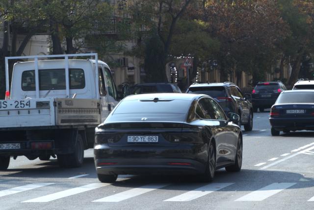 (251117) -- BAKU, Nov. 17, 2025 (Xinhua) -- A car of Nio brand (R, front) is seen on a street of Baku, Azerbaijan, on Nov. 16, 2025. In the eyes of locals in Baku, Chinese cars are cost-effective, energy-saving, and environmentally friendly, so more and more people are choosing to buy Chinese cars. (Xinhua/Chen Junfeng)
