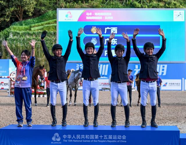 (251117) -- SHENZHEN, Nov. 17, 2025 (Xinhua) -- Gold medalists team Guangxi pose with their coach during the awarding ceremony after the jumping team final of equestrian at China's 15th National Games in Shenzhen, south China's Guangdong Province, Nov. 17, 2025. (Xinhua/Feng Kaihua)