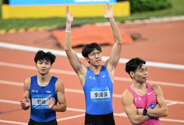 (251117) -- GUANGZHOU, Nov. 17, 2025 (Xinhua) -- Li Zeyang (C) of Hubei reacts after the men's 100m final of athletics at China's 15th National Games in Guangzhou, south China's Guangdong Province, Nov. 17, 2025. (Xinhua/Deng Hua)