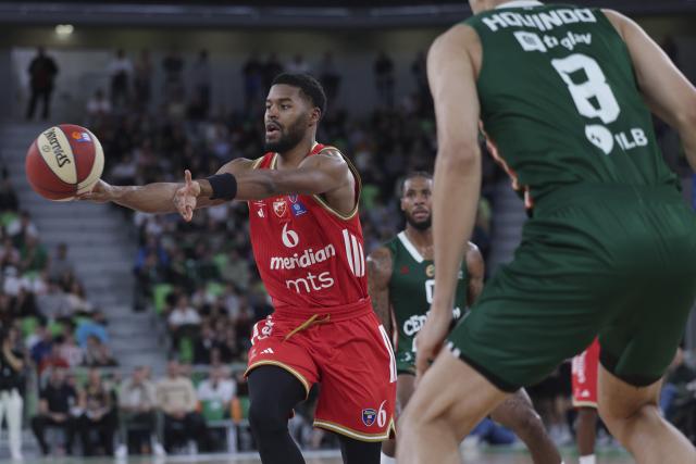 (251118) -- LJUBLJANA, Nov. 18, 2025 (Xinhua) -- Jared Butler (L) of Crvena Zvezda Meridianbet passes the ball during the ABA League basketball match between Cedevita Olimpija Ljubljana and Crvena Zvezda Meridianbet in Ljubljana, Slovenia, Nov. 17, 2025. (Photo by Zeljko Stevanic/Xinhua)