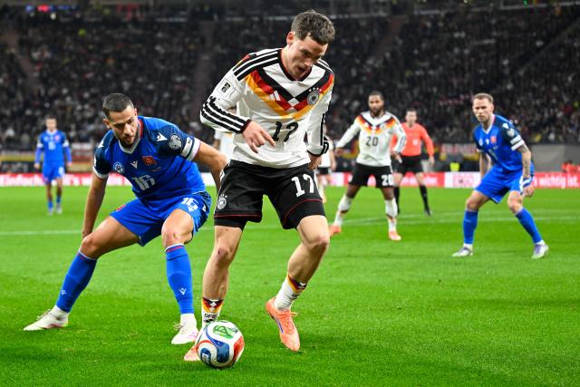 (251118) -- LEIPZIG, Nov. 18, 2025 (Xinhua) -- Florian Wirtz (front R) of Germany vies with David Hancko (front L) of Slovakia during the 2026 World Cup European Qualifiers football match between Germany and Slovakia in Leipzig, Germany, Nov. 17, 2025. (Photo by Ulrich Hufnagel/Xinhua)