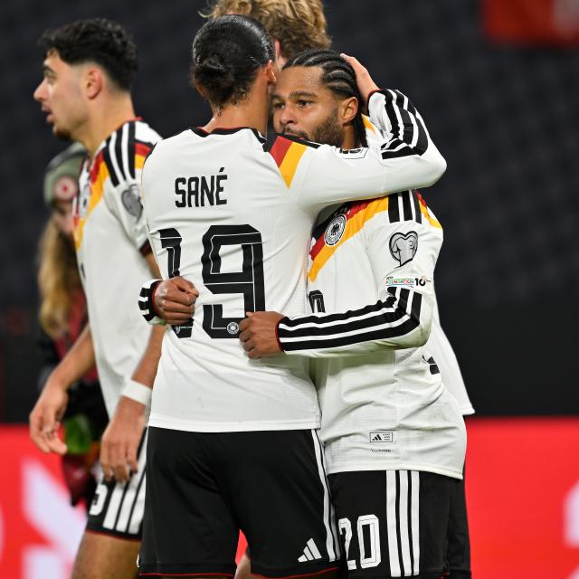 (251118) -- LEIPZIG, Nov. 18, 2025 (Xinhua) -- Serge Gnabry (R, front) of Germany celebrates scoring with his teammate Leroy Sane during the 2026 World Cup European Qualifiers football match between Germany and Slovakia in Leipzig, Germany, Nov. 17, 2025. (Photo by Ulrich Hufnagel/Xinhua)