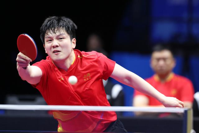 (251118) -- MACAO, Nov. 18, 2025 (Xinhua) -- Fan Zhendong of Shanghai hits a return in the match against Liang Jingkun of Hebei during the men's team quarterfinal match of table tennis between Shanghai and Hebei at China's 15th National Games in Macao, south China, Nov. 18, 2025. (Xinhua/Liu Xu)