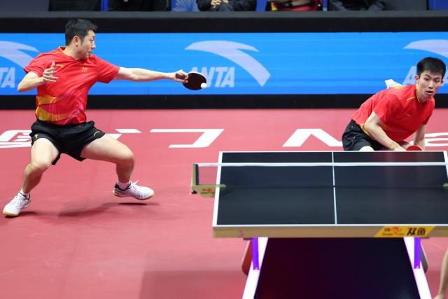 (251118) -- MACAO, Nov. 18, 2025 (Xinhua) -- Xu Xin (L)/Zhou Kai of Shanghai compete against Zhou Yu/Liang Yanning of Hebei during the men's team quarterfinal match of table tennis between Shanghai and Hebei at China's 15th National Games in Macao, south China, Nov. 18, 2025. (Xinhua/Liu Xu)