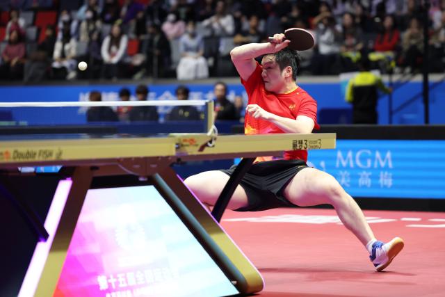 (251118) -- MACAO, Nov. 18, 2025 (Xinhua) -- Fan Zhendong of Shanghai hits a return in the match against Liang Jingkun of Hebei during the men's team quarterfinal match of table tennis between Shanghai and Hebei at China's 15th National Games in Macao, south China, Nov. 18, 2025. (Xinhua/Liang Xu)