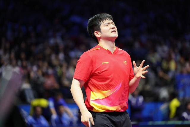 (251118) -- MACAO, Nov. 18, 2025 (Xinhua) -- Fan Zhendong of Shanghai reacts in the match against Liang Jingkun of Hebei during the men's team quarterfinal match of table tennis between Shanghai and Hebei at China's 15th National Games in Macao, south China, Nov. 18, 2025. (Xinhua/Liang Xu)