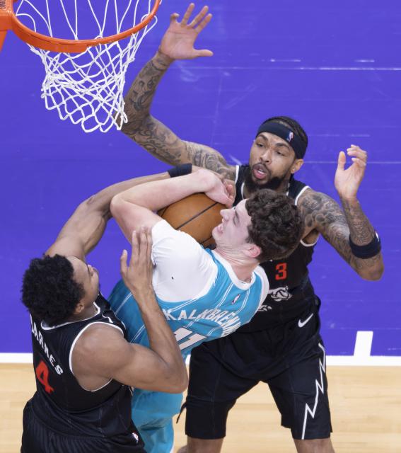 (251118) -- TORONTO, Nov. 18, 2025 (Xinhua) -- Brandon Ingram (R) and Scottie Barnes (L) of Toronto Raptors vie with Ryan Kalkbrenner of Charlotte Hornets during the 2025-2026 NBA regular season match between Toronto Raptors and Charlotte Hornets in Toronto, Canada, on Nov. 17, 2025. (Photo by Zou Zheng/Xinhua)