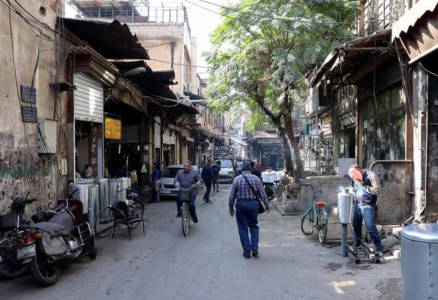 (251118) -- DAMASCUS, Nov. 18, 2025 (Xinhua) -- People walk down a street in the old Haddadin market in central Damascus, Syria, Nov. 17, 2025. Artisans have been returning to Damascus' historic markets to revive traditional trades that lost much of their prominence during years of war. (Photo by Ammar Safarjalani/Xinhua)