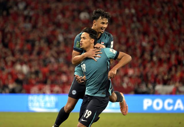 (251118) -- HONG KONG, Nov. 18, 2025 (Xinhua) -- Ilhan Fandi (front) and Ikhsan Fandi of Singapore celebrate during the AFC Asian Cup 2027 Qualifiers 3rd round group C football match between China's Hong Kong and Singapore in Hong Kong, south China, Nov. 18, 2025. (Xinhua/Lo Ping Fai)
