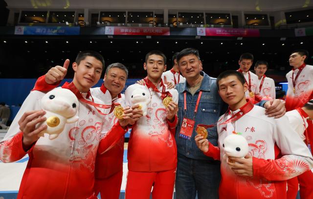 (251118) -- MACAO, Nov. 18, 2025 (Xinhua) -- Athletes of Guangdong pose with Du Feng (2nd R) after the awarding ceremony for U18 men's basketball at China's 15th National Games in Macao, south China, Nov. 18, 2025. (Xinhua/Sun Fanyue)
