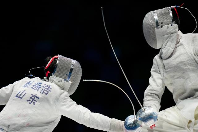 (251118) -- HONG KONG, Nov. 18, 2025 (Xinhua) -- Wei Zhenhao (L) of Shandong competes against Deng Xiaohao of Guangdong during the men's team sabre final of fencing at China's 15th National Games in Hong Kong, south China, Nov. 18, 2025. (Xinhua/Wu Lu)