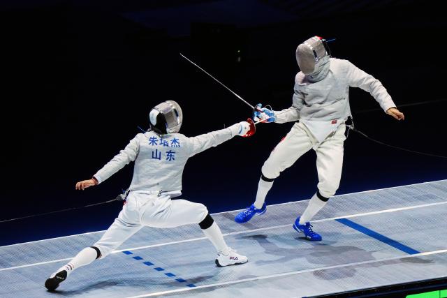 (251118) -- HONG KONG, Nov. 18, 2025 (Xinhua) -- Zhu Peijie (L) of Shandong competes against Deng Xiaohao of Guangdong during the men's team sabre final of fencing at China's 15th National Games in Hong Kong, south China, Nov. 18, 2025. (Xinhua/Zhu Wei)