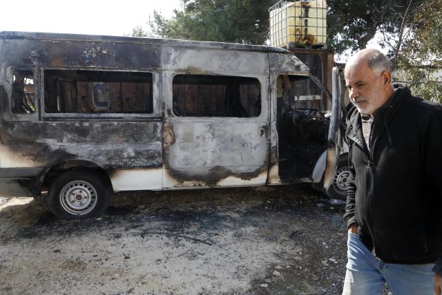(251118) -- BETHLEHEM, Nov. 18, 2025 (Xinhua) -- A Palestinian walks past a burned vehicle in Al-Jaba village, West Bank city of Bethlehem, on Nov. 18, 2025. According to the official WAFA news agency, Israeli settlers on Monday evening torched several homes and vehicles in Al-Jaba village. (Photo by Mamoun Wazwaz/Xinhua)