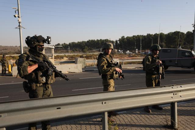 (251118) -- JERUSALEM, Nov. 18, 2025 (Xinhua) -- Security forces cordon off the scene of a ramming and stabbing attack at the Gush Etzion Junction, a major intersection in a settlement bloc south of Jerusalem, in the occupied West Bank, Nov. 18, 2025. An Israeli man was killed and three others wounded in a ramming and stabbing attack in the occupied West Bank on Tuesday, carried out by two Palestinian suspects who were subsequently shot dead by security forces, Israeli officials said. (Photo by Jamal Awad/Xinhua)