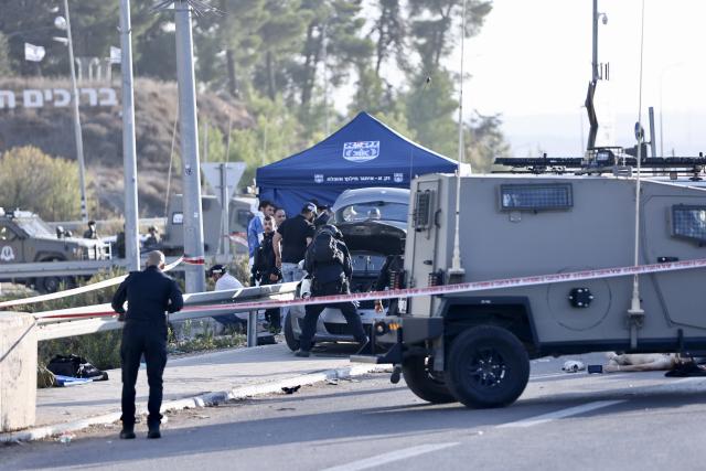 (251118) -- JERUSALEM, Nov. 18, 2025 (Xinhua) -- Security forces work at the scene of a ramming and stabbing attack at the Gush Etzion Junction, a major intersection in a settlement bloc south of Jerusalem, in the occupied West Bank, Nov. 18, 2025. An Israeli man was killed and three others wounded in a ramming and stabbing attack in the occupied West Bank on Tuesday, carried out by two Palestinian suspects who were subsequently shot dead by security forces, Israeli officials said. (Photo by Jamal Awad/Xinhua)