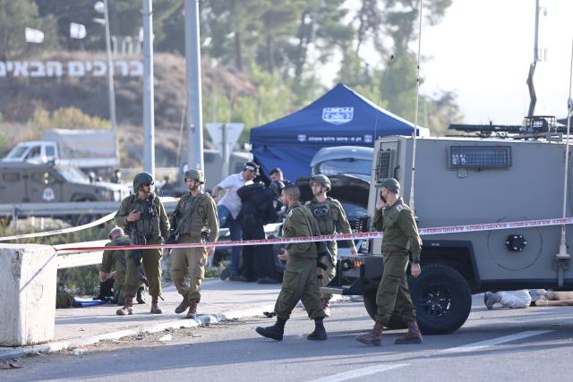 (251118) -- JERUSALEM, Nov. 18, 2025 (Xinhua) -- Security forces cordon off the scene of a ramming and stabbing attack at the Gush Etzion Junction, a major intersection in a settlement bloc south of Jerusalem, in the occupied West Bank, Nov. 18, 2025. An Israeli man was killed and three others wounded in a ramming and stabbing attack in the occupied West Bank on Tuesday, carried out by two Palestinian suspects who were subsequently shot dead by security forces, Israeli officials said. (Photo by Jamal Awad/Xinhua)