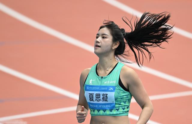 (251119) -- GUANGZHOU, Nov. 19, 2025 (Xinhua) -- Xia Sining of Hunan reacts after the women's 100m hurdles heat of athletics at China's 15th National Games in Guangzhou, south China's Guangdong Province, Nov. 19, 2025. (Xinhua/Deng Hua)