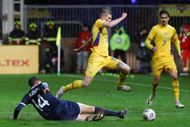(251119) -- PLOIESTI, Nov. 19, 2025 (Xinhua) -- Romania's Florin Tanase (top) vies with San Marino's Giacomo Valentini (bottom) during the 2026 World Cup European Qualifiers football match between Romania and San Marino in Ploiesti, Romania, Nov. 18, 2025. (Photo by Cristian Cristel/Xinhua)