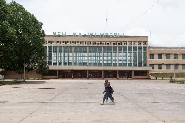 (251119) -- LUSAKA, Nov. 19, 2025 (Xinhua) -- Two kids walk past New Kapiri Mposhi Railway Station in Central Province, Zambia, Nov. 14, 2025. TO GO WITH "Feature: Tazara Railway enters new chapter of China-Africa friendship" (Xinhua/Peng Lijun)