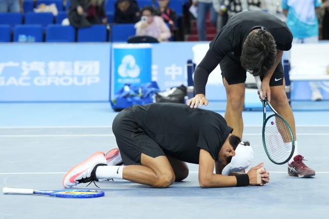 (251119) -- HENGQIN, Nov. 19, 2025 (Xinhua) -- Tang Sheng/Sun Qian (bottom) react after winning the tennis men's doubles final between Tang Sheng/Sun Qian of Jiangsu and Bu Yunchaokete/Zheng Zhan of Zhejiang at China's 15th National Games in Hengqin, south China's Guangdong Province, Nov. 19, 2025. (Xinhua/Yan Linyun)